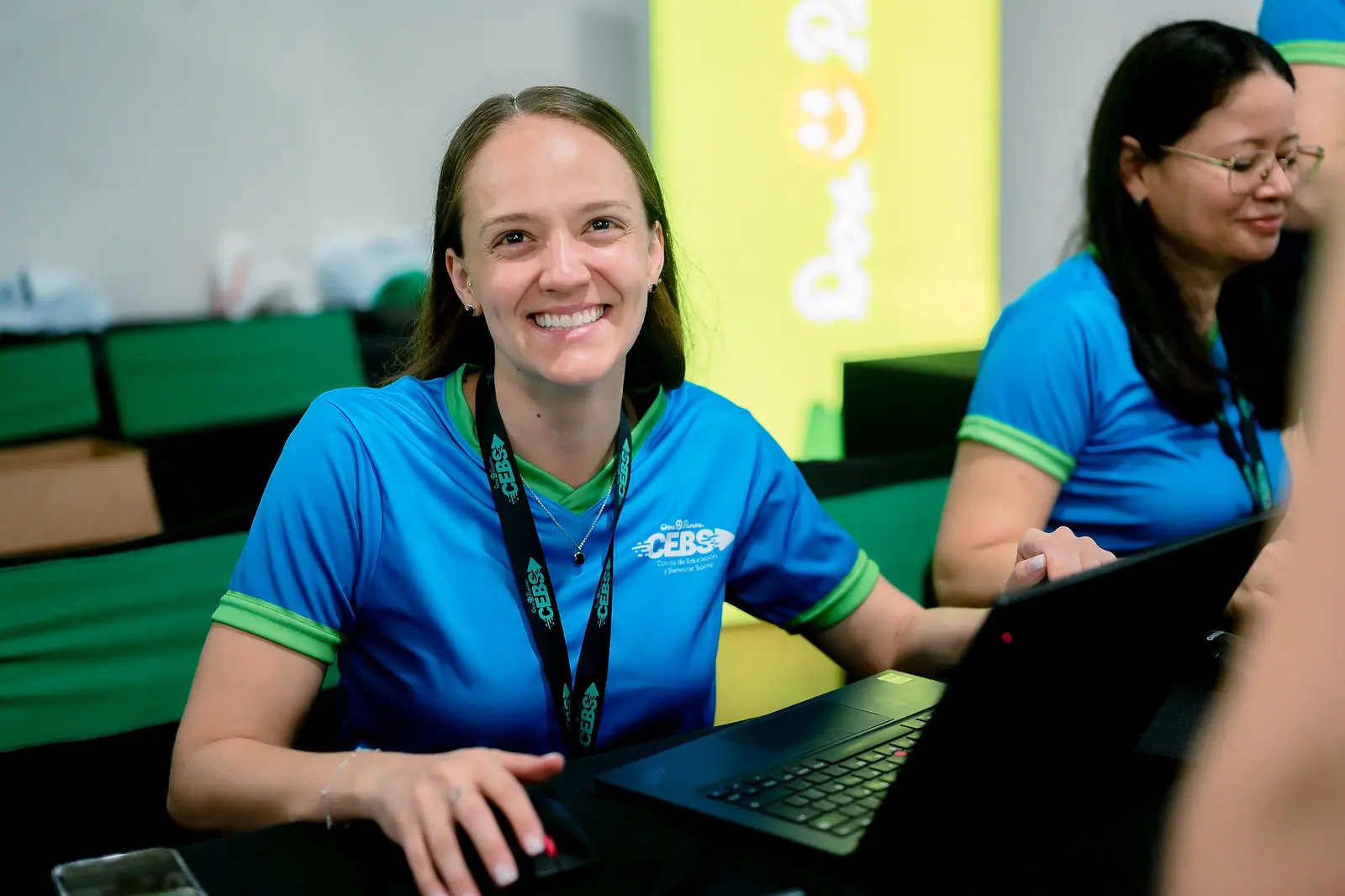 Attendee smiling at the booth during the event