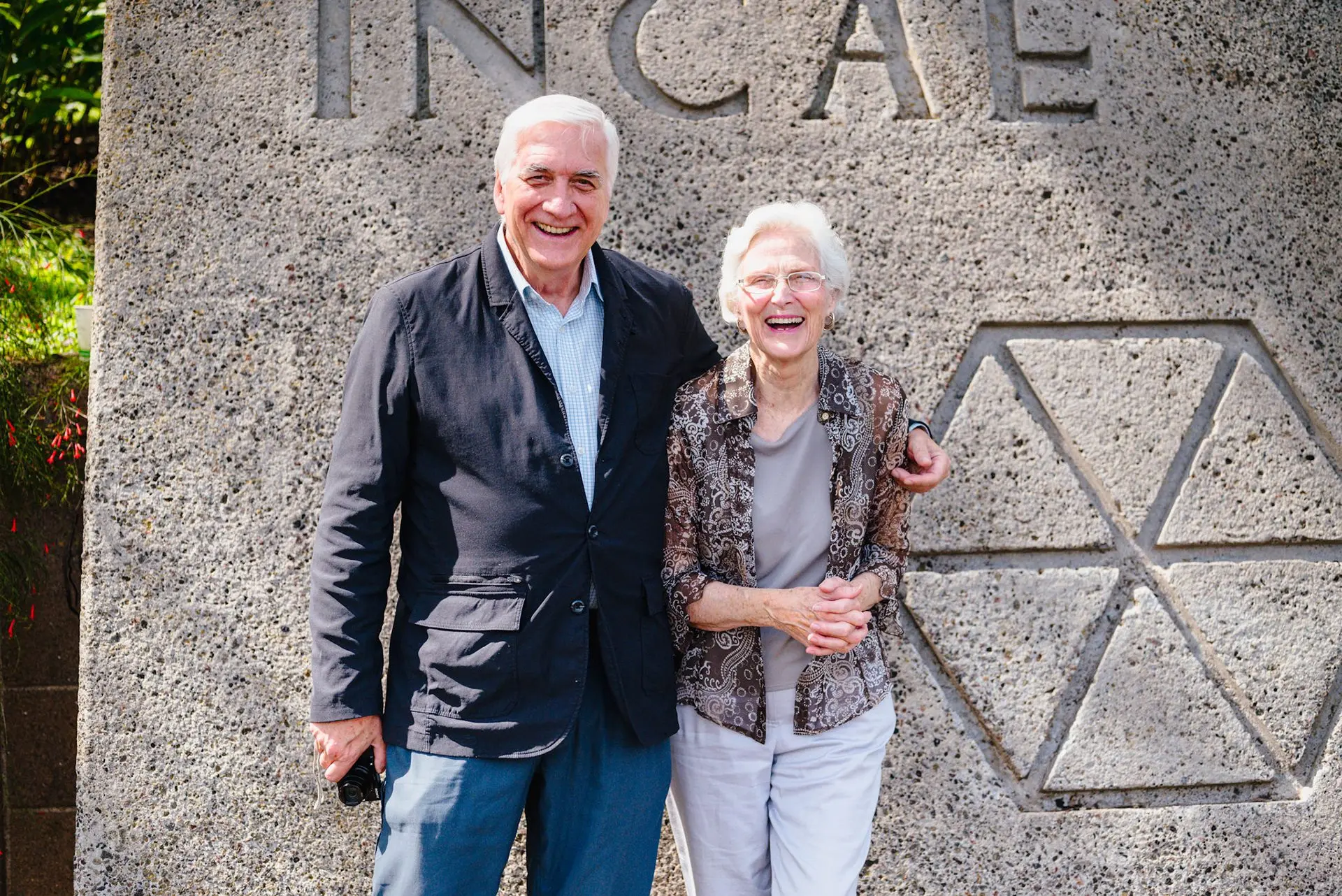 Guests next to the INCAE logo